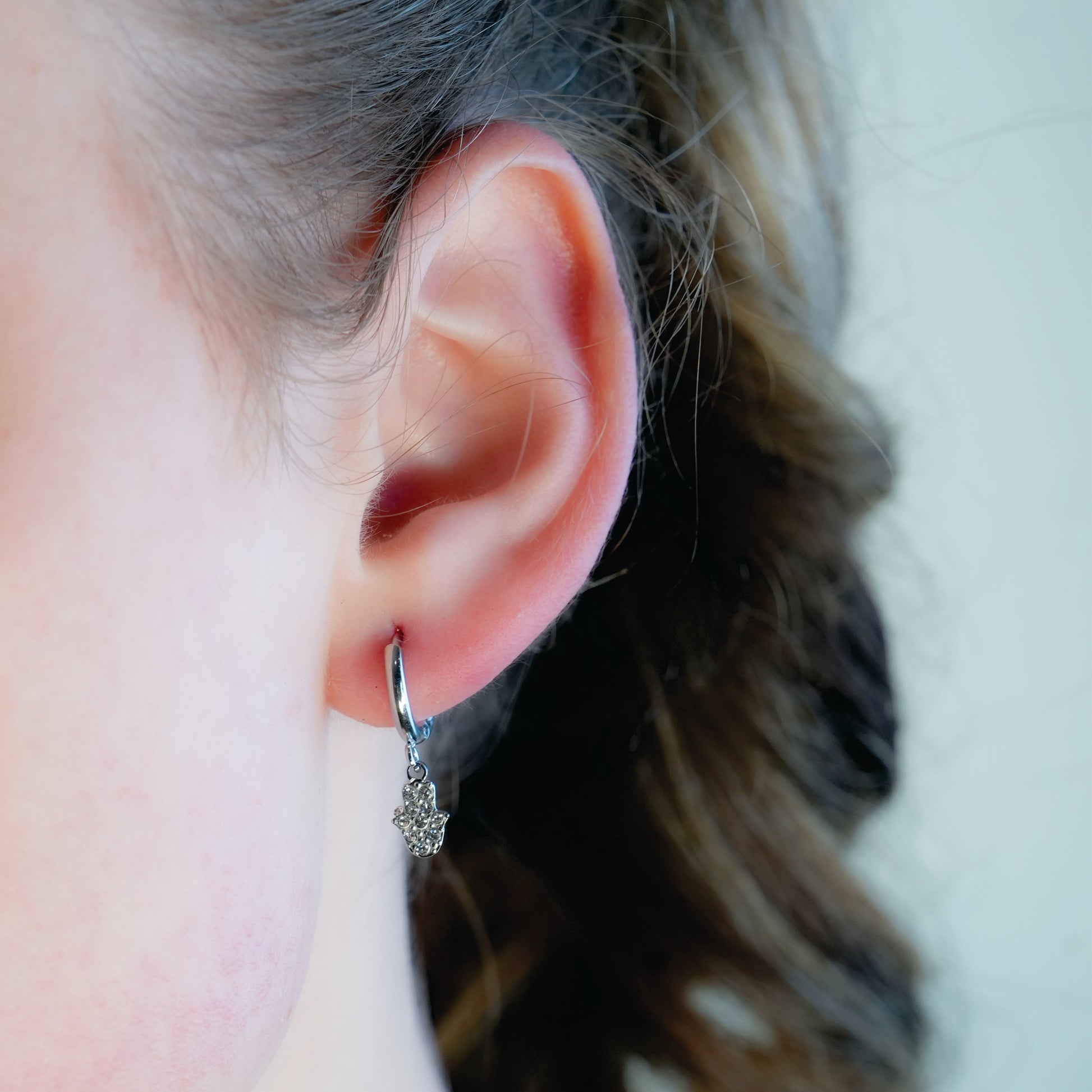 FATIMA White Gold (Silver Toned): Pavé Zirconia (CZ) Mini Hoop Earrings with Hamsa Hand Charm – A Perfect Blend of Style and Protection - Velora Luxury Fashion