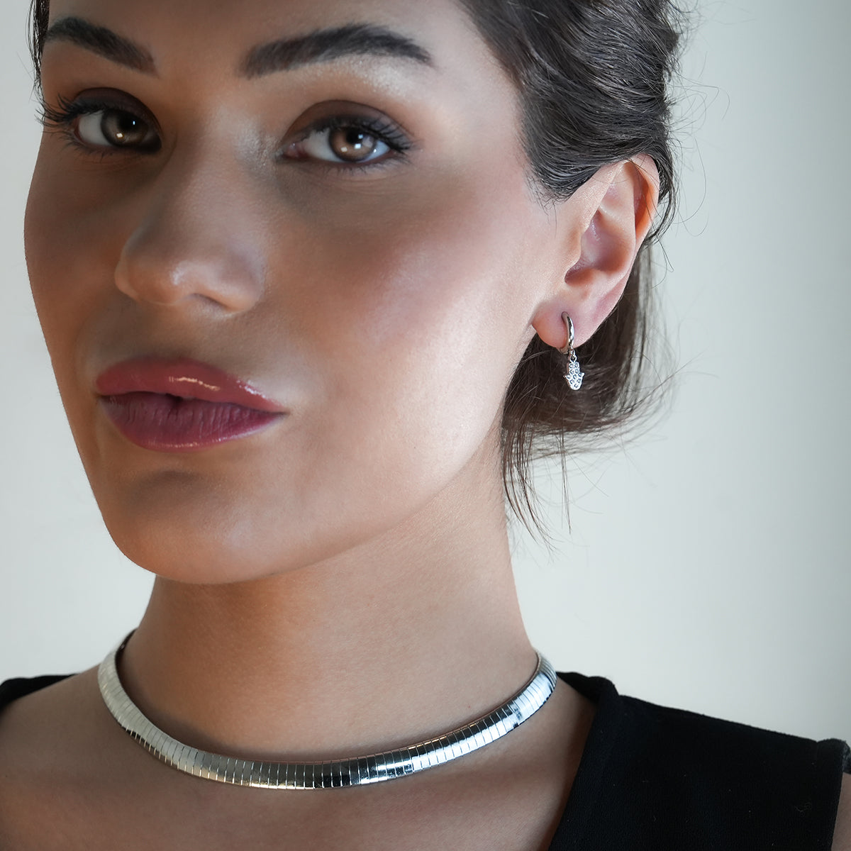 FATIMA White Gold (Silver Toned): Pavé Zirconia (CZ) Mini Hoop Earrings with Hamsa Hand Charm – A Perfect Blend of Style and Protection - Velora Luxury Fashion