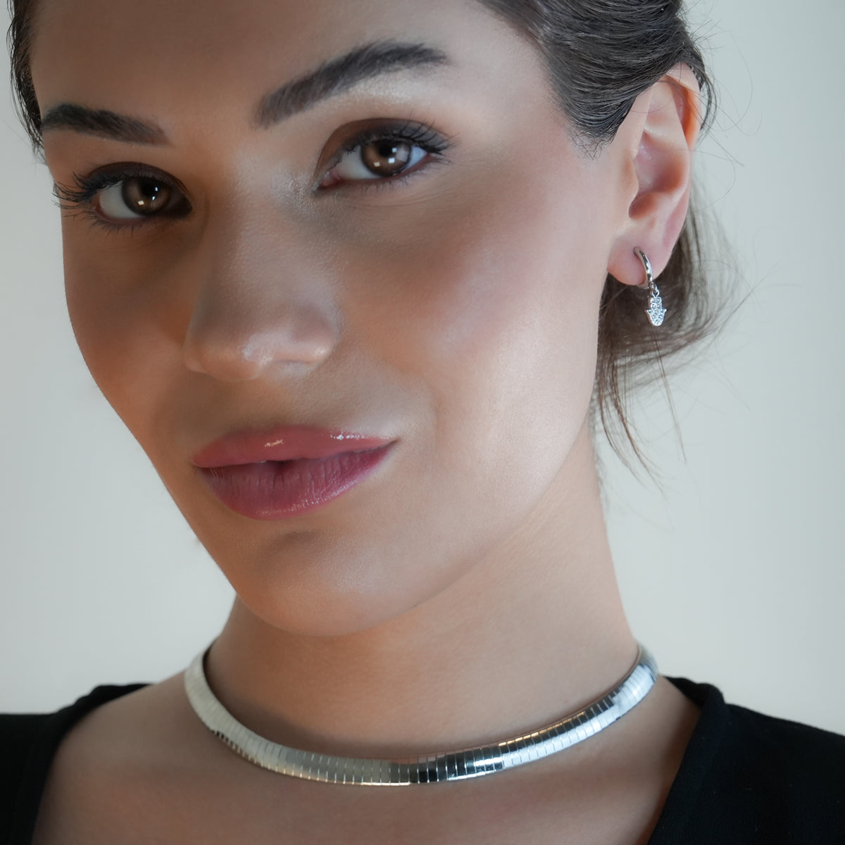 FATIMA White Gold (Silver Toned): Pavé Zirconia (CZ) Mini Hoop Earrings with Hamsa Hand Charm – A Perfect Blend of Style and Protection - Velora Luxury Fashion