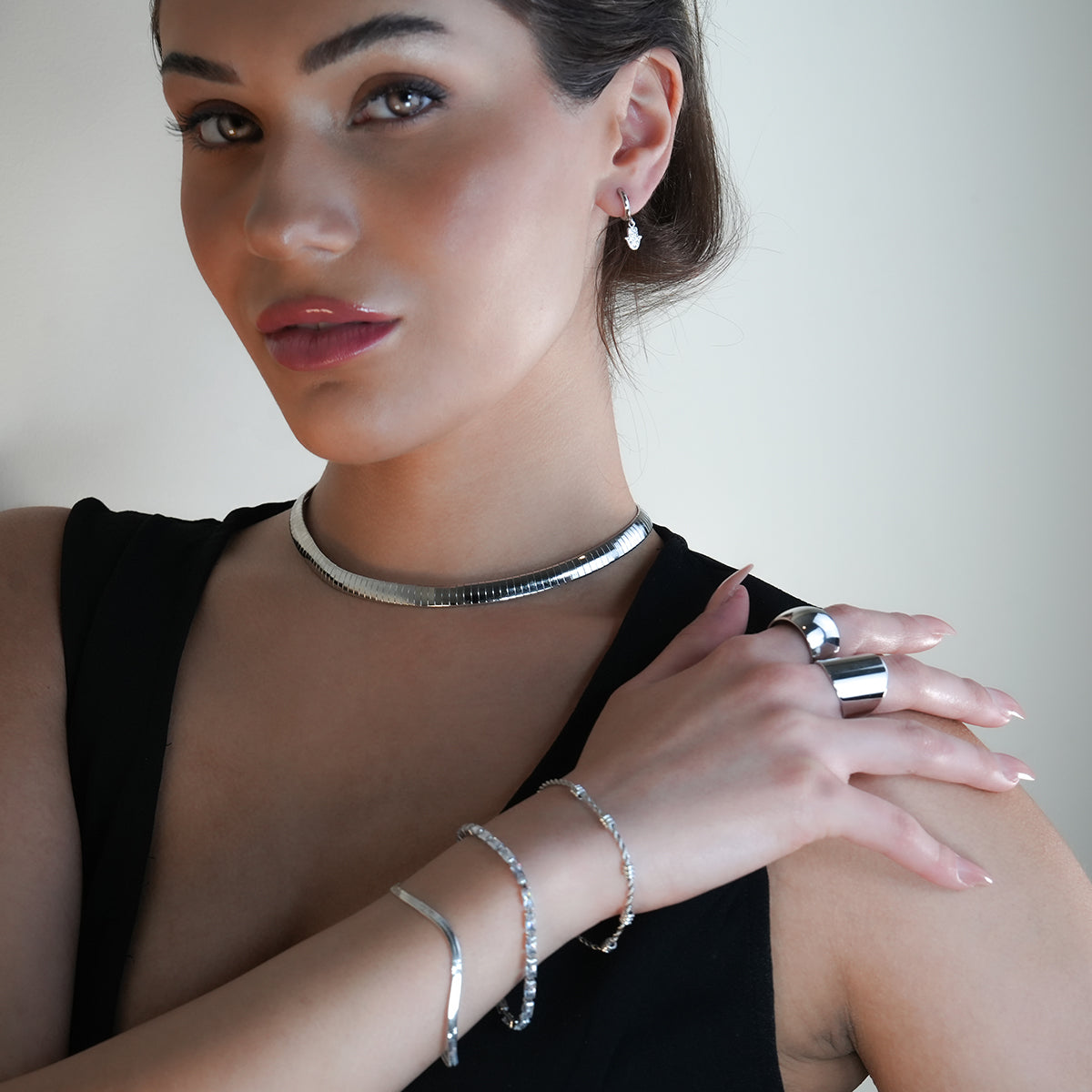 FATIMA White Gold (Silver Toned): Pavé Zirconia (CZ) Mini Hoop Earrings with Hamsa Hand Charm – A Perfect Blend of Style and Protection - Velora Luxury Fashion