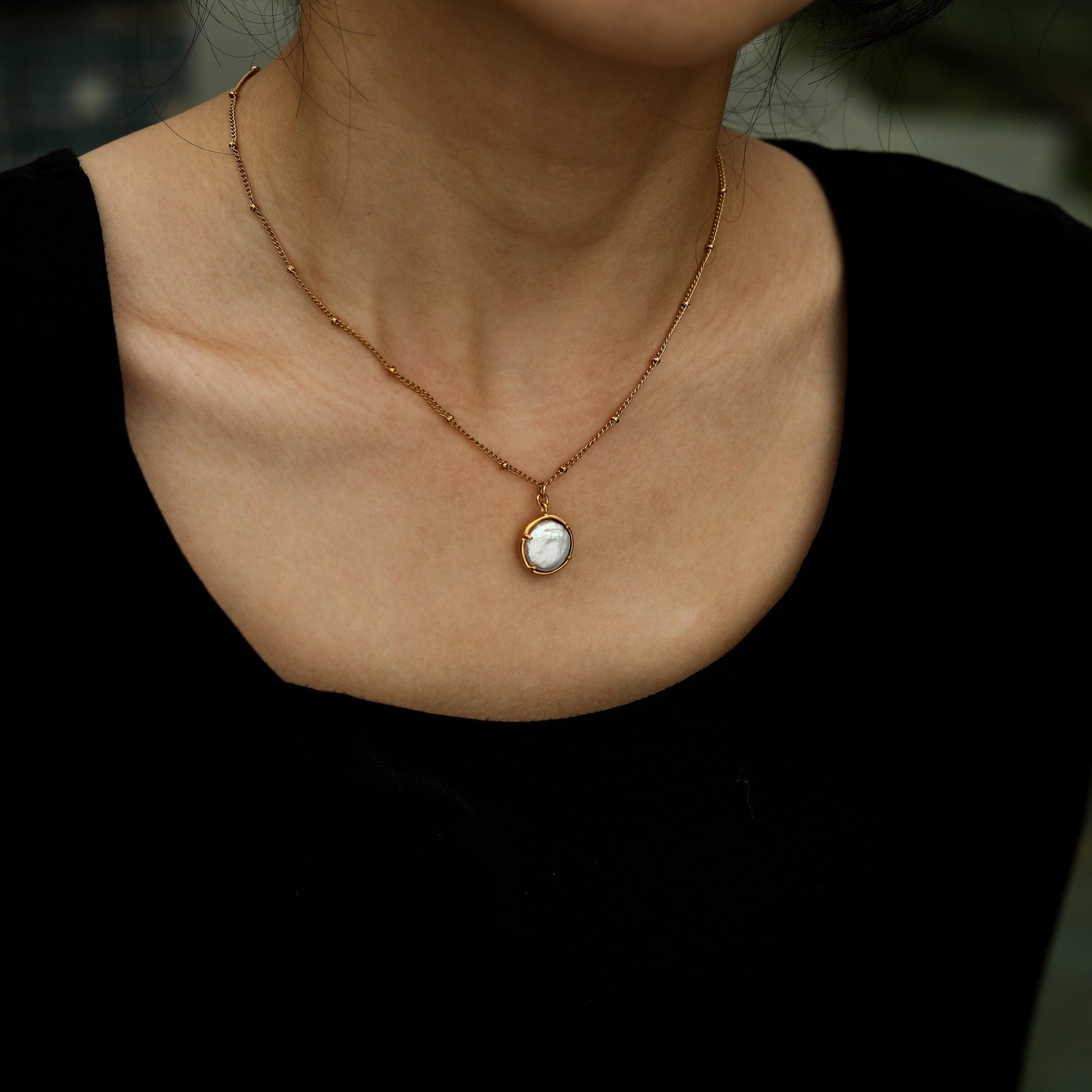 LERATI: Beaded Chain with an Encased Fresh Water Pearl Pendant in Gold - Velora Luxury Fashion