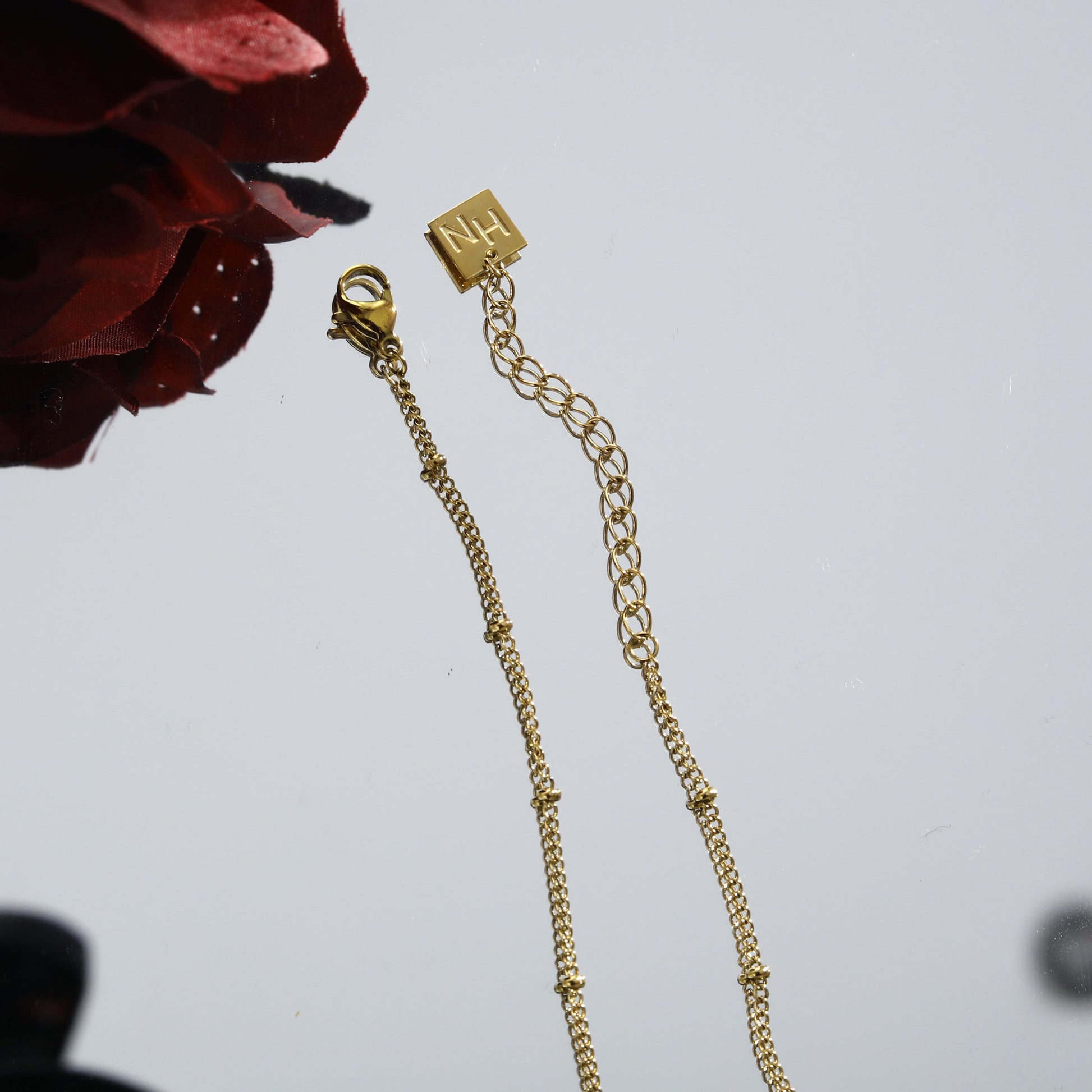 LERATI: Beaded Chain with an Encased Fresh Water Pearl Pendant in Gold - Velora Luxury Fashion