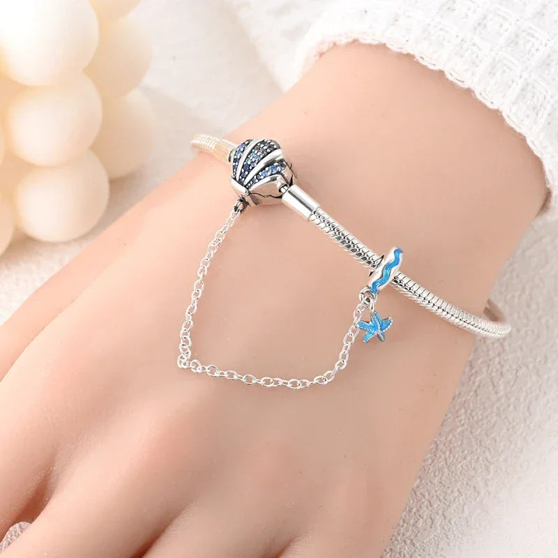 Sterling Silver Seashell Charm Bracelet with Blue CZ Gradient - Velora Luxury Fashion